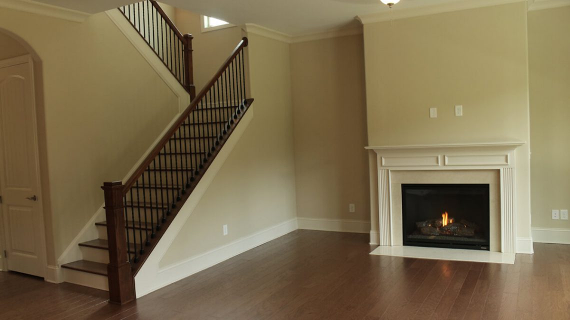 Clean white fireplace by stairs